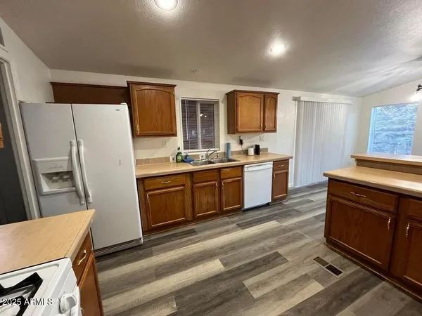 a kitchen with a stove a refrigerator and a sink