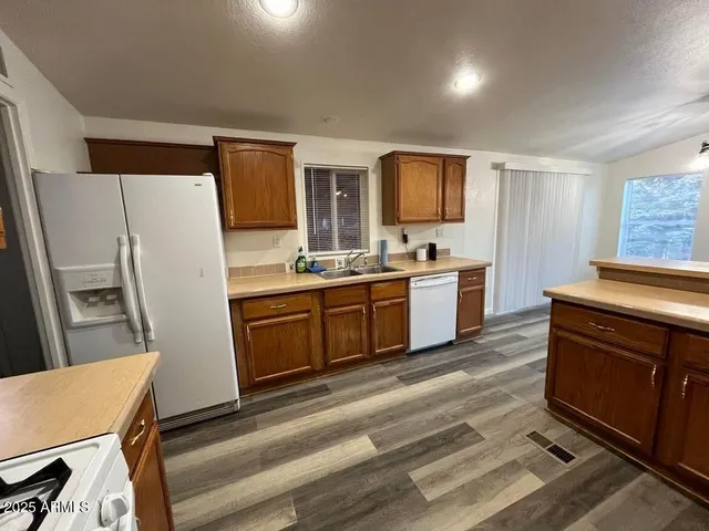 a kitchen with a stove a refrigerator and a sink
