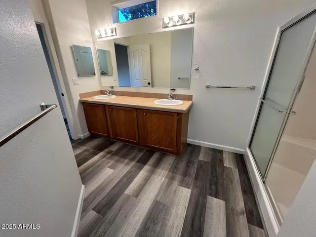 a bathroom with a sink a mirror and vanity