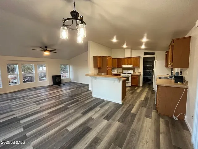 a view of kitchen with sink microwave and refrigerator