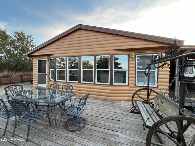 a view of a house with backyard and sitting area