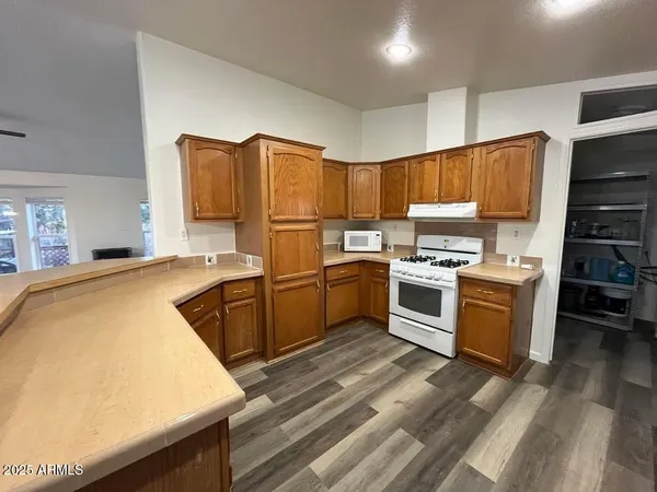 a kitchen with a stove a sink and a refrigerator