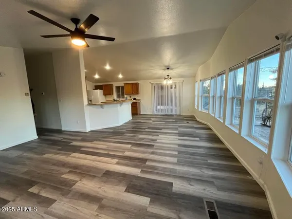 a view of a hallway with a ceiling fan
