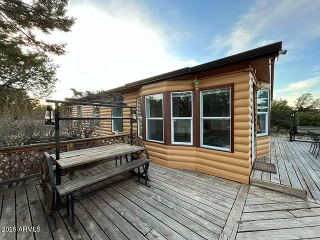 a view of a wooden bench on the roof deck