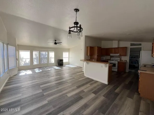 a view of a living room a kitchen and a window