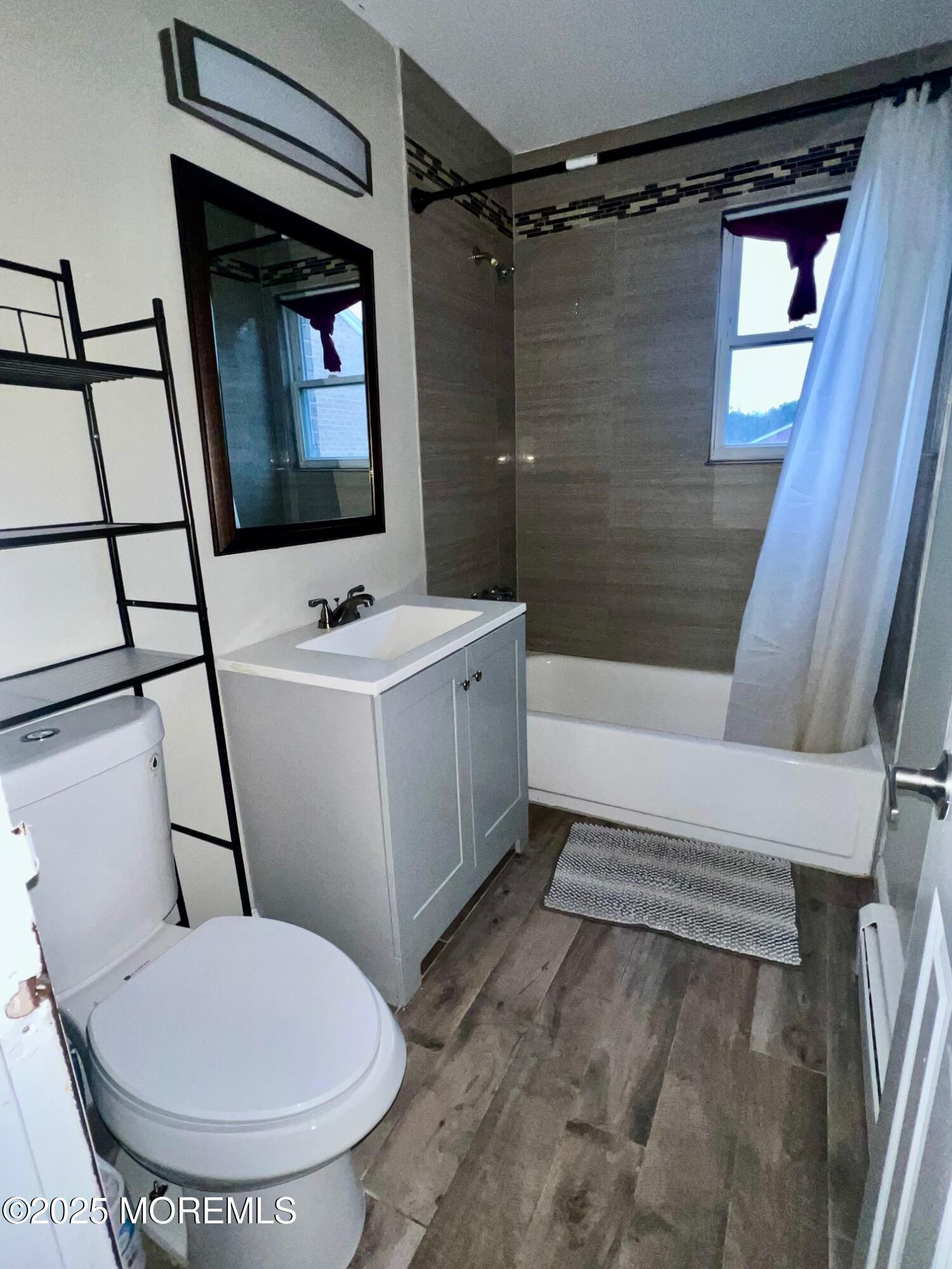 12 Manchester Court, Unit H Freehold, NJ 07728 - Photo 8 of 11 a bathroom with a sink toilet and shower