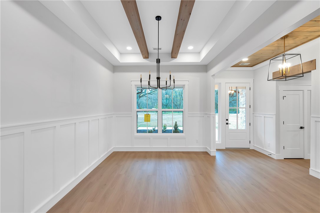 4554 Flat Rock Road Iva, SC 29655 - Photo 14 of 32 A grand entrance with intricate wainscoting and warm wood flooring welcomes visitors inside.