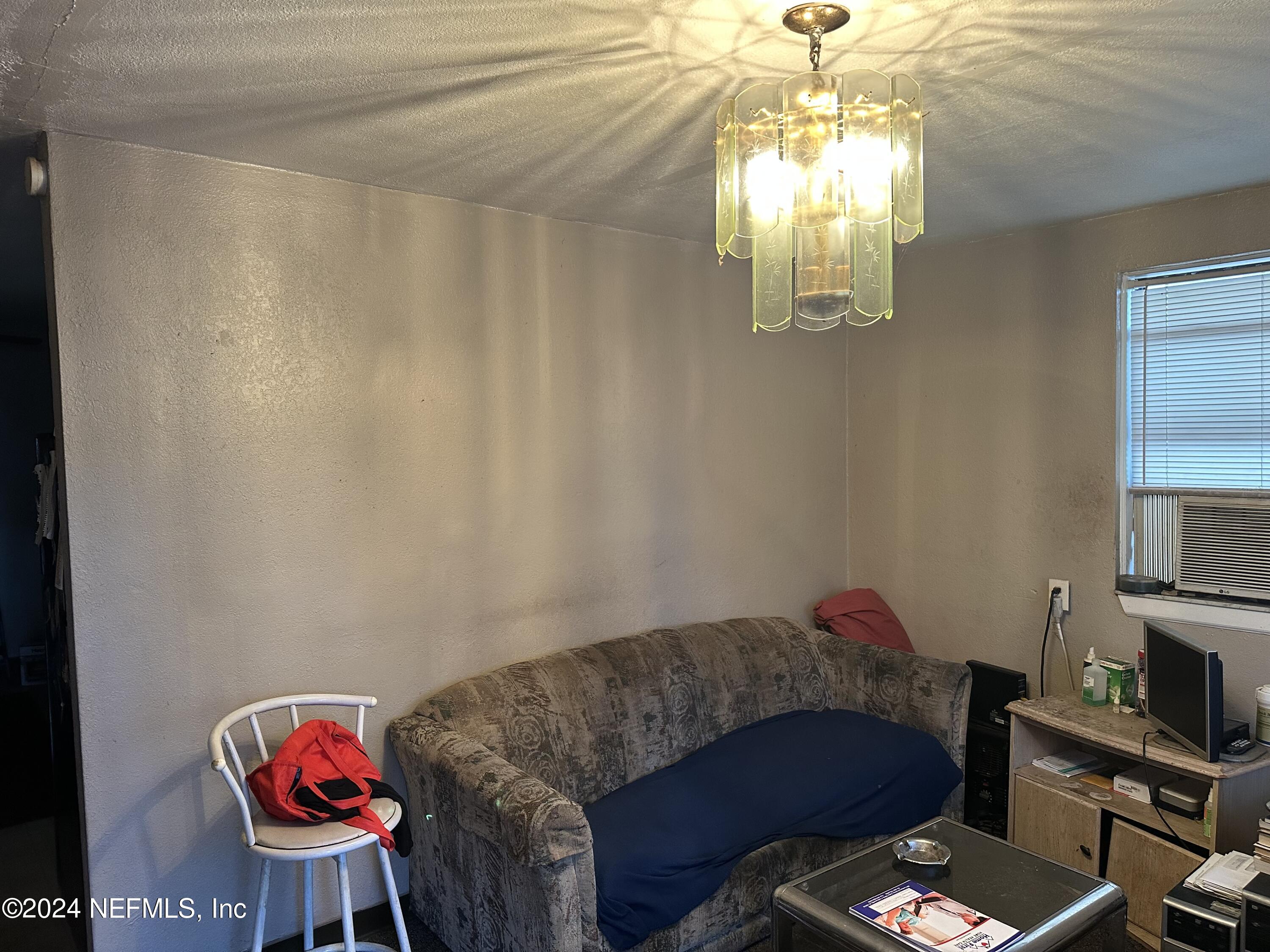 4114 Moncrief Road Jacksonville, FL 32209 - Photo 12 of 15 a living room with furniture and a chandelier
