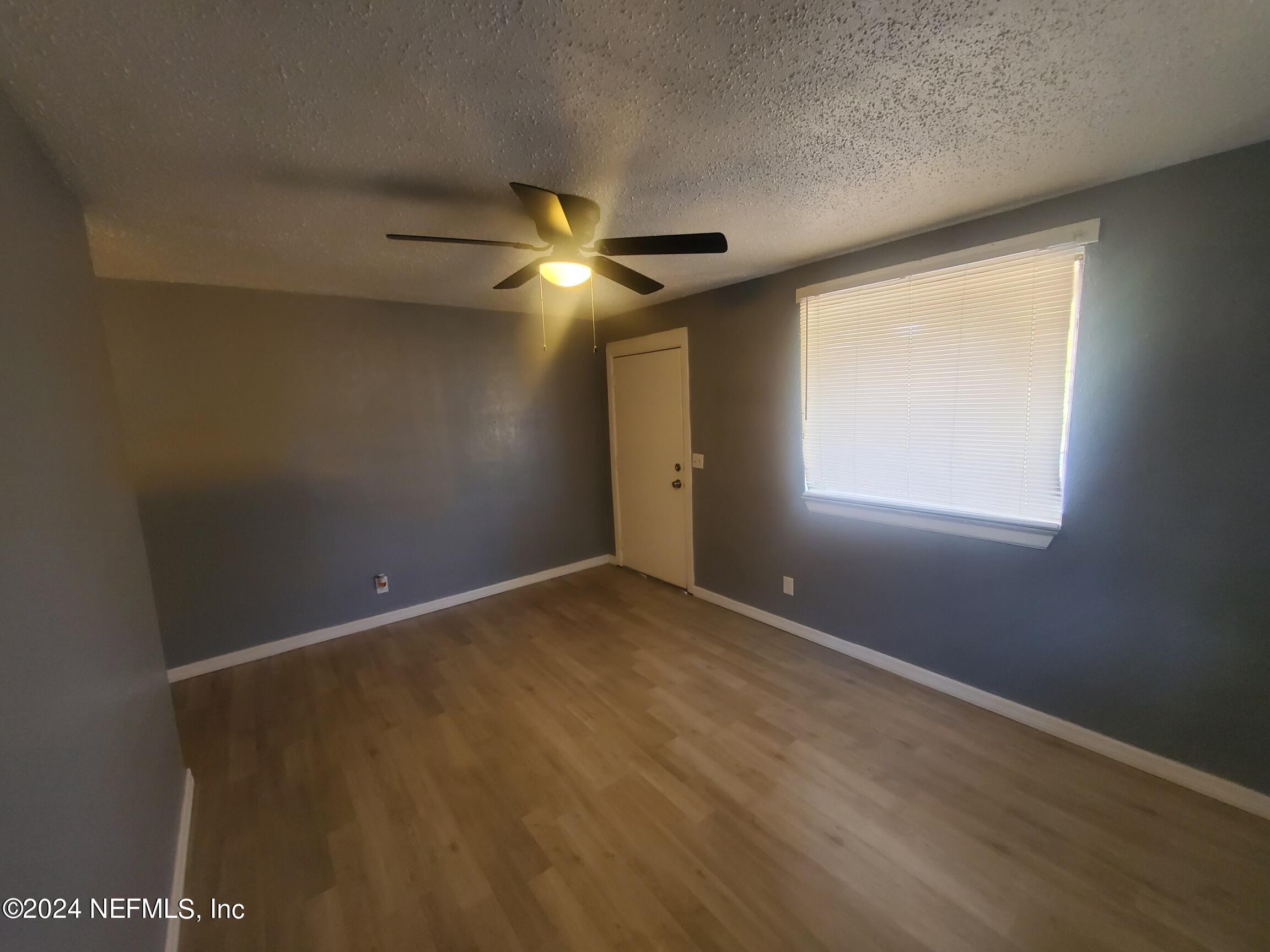 4114 Moncrief Road Jacksonville, FL 32209 - Photo 13 of 15 an empty room with a window and a fan