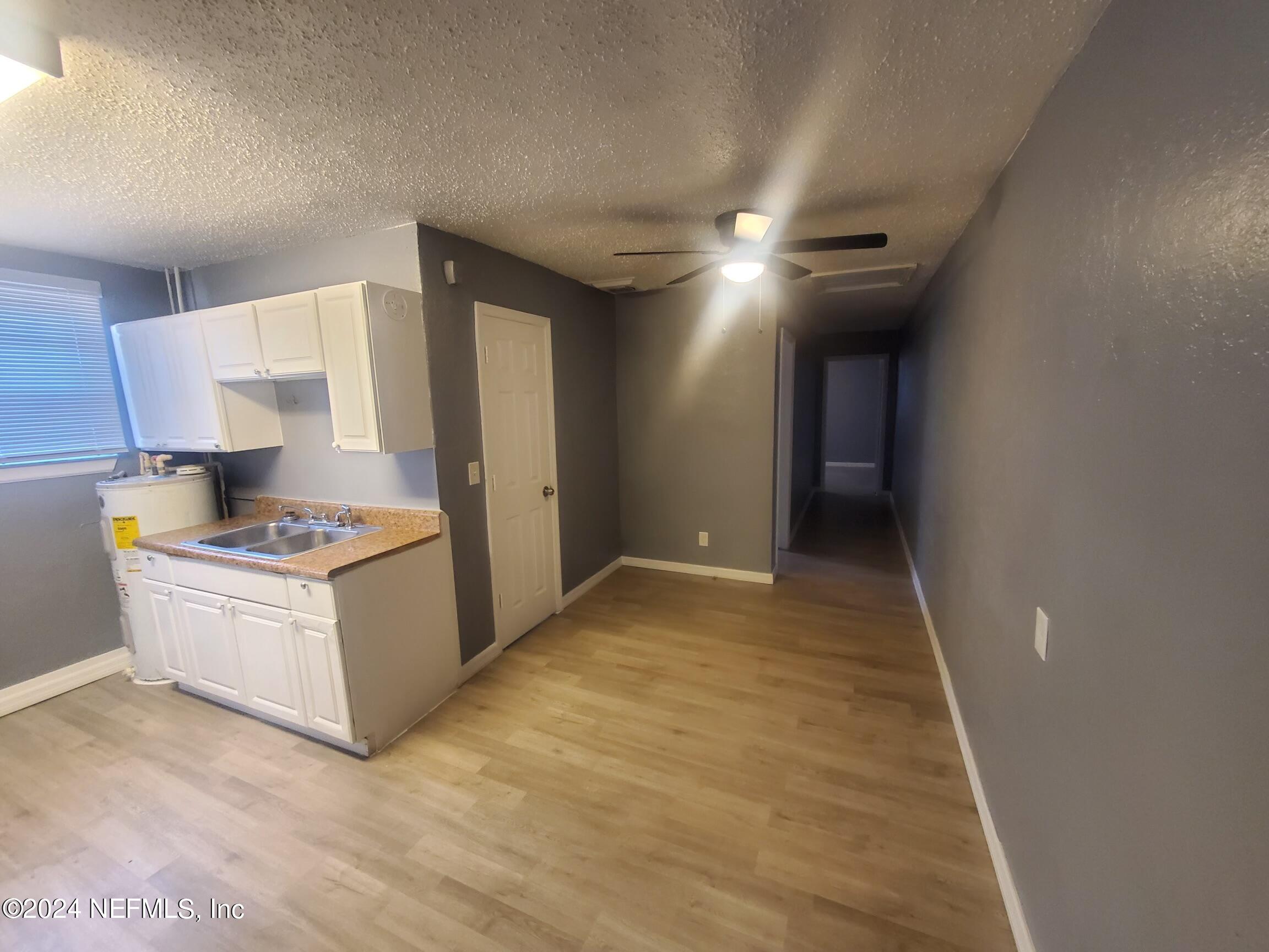 4114 Moncrief Road Jacksonville, FL 32209 - Photo 15 of 15 a kitchen with stainless steel appliances granite countertop a sink and a refrigerator