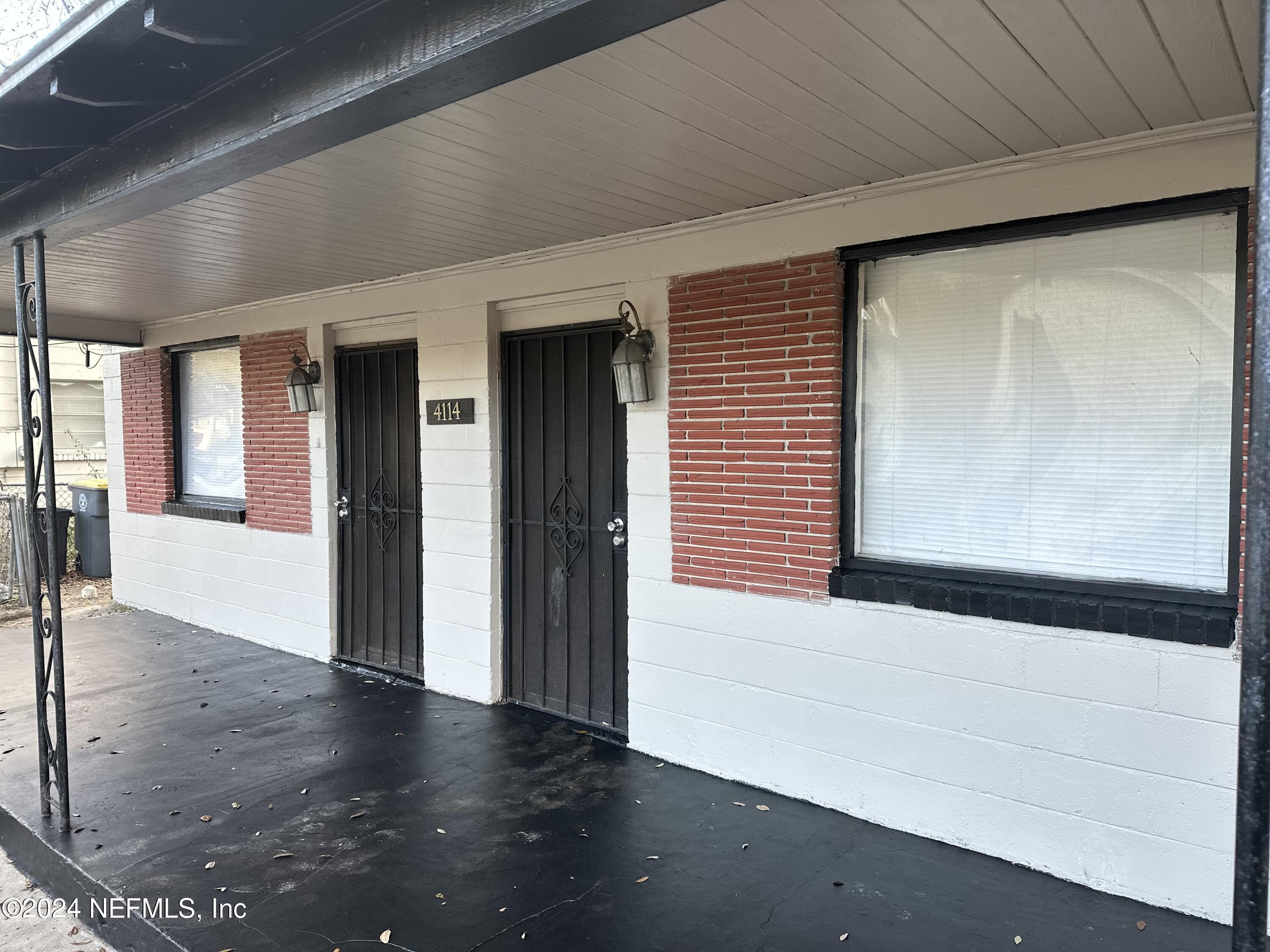 4114 Moncrief Road Jacksonville, FL 32209 - Photo 2 of 15 a view of an empty room with wooden floor and a window