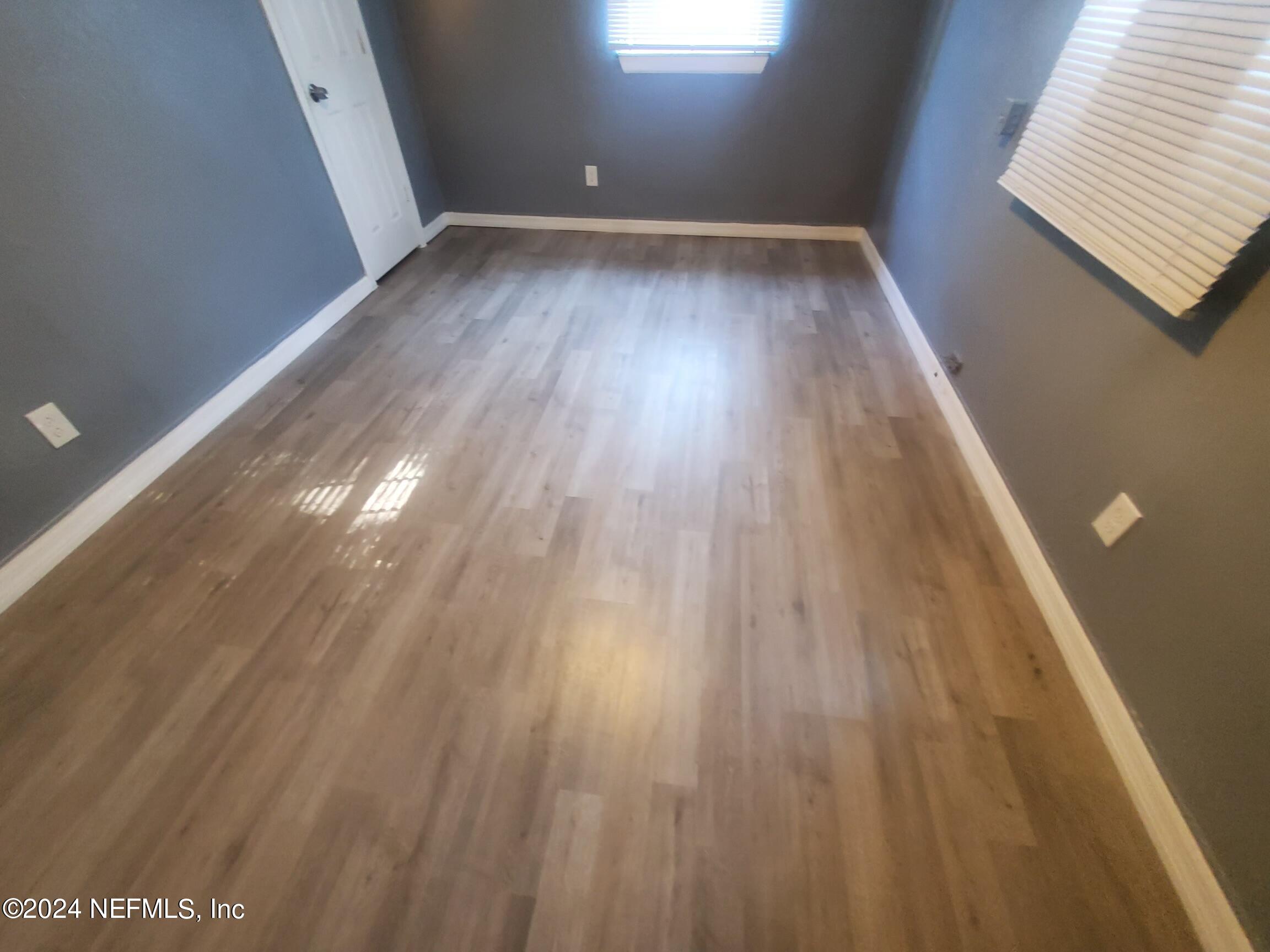 4114 Moncrief Road Jacksonville, FL 32209 - Photo 5 of 15 a view of room with window and hardwood floor
