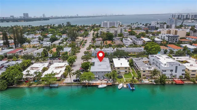 an aerial view of multiple houses with yard