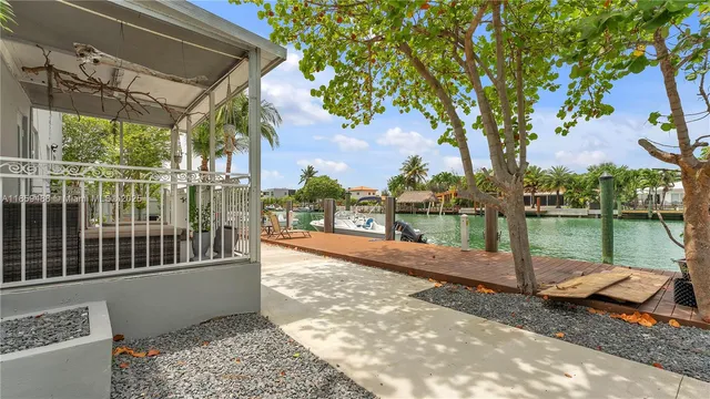 a view of a patio with a table chairs and a backyard