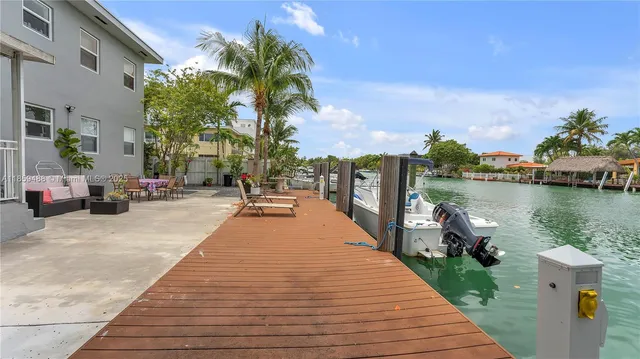 a park with water view and palm trees