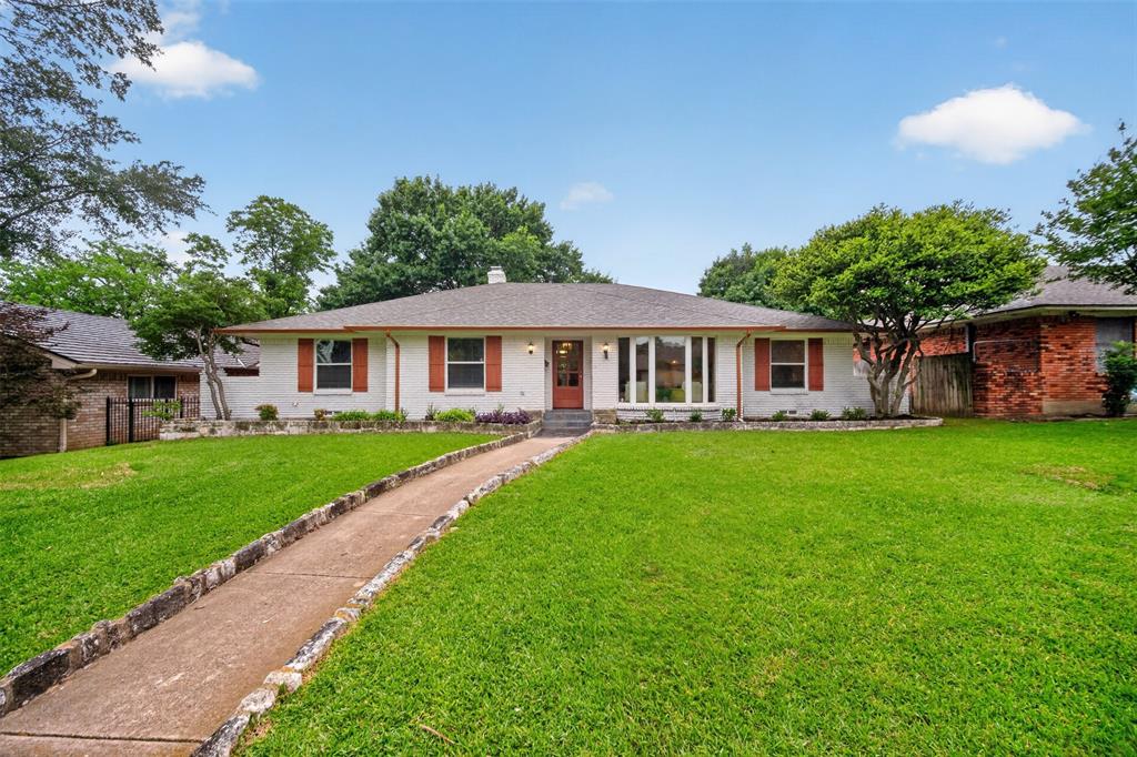 9660 Timberleaf Drive Dallas, TX 75243 - Photo 1 of 40 Single-story residence featuring a light-colored brick exterior, a dark-toned shingle roof, and a concrete pathway with stone border