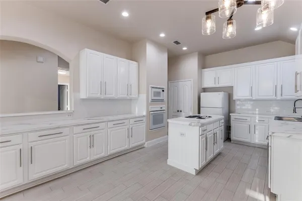 a kitchen with stainless steel appliances granite countertop a stove oven and a refrigerator