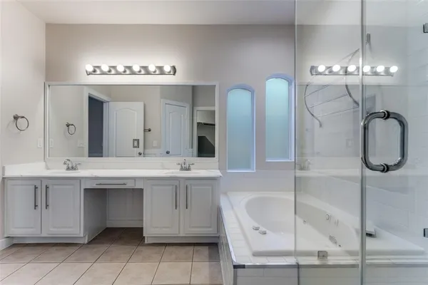a spacious bathroom with a sink a mirror and a bathtub