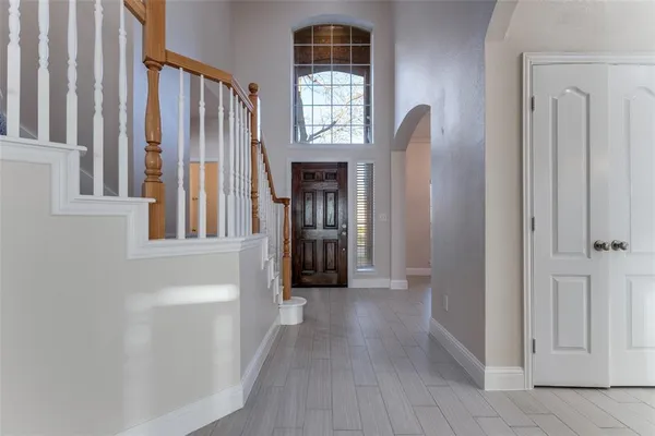 a view of a hallway with windows and stairs