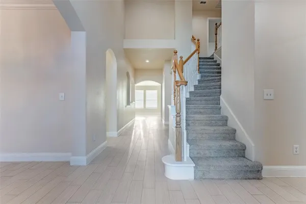 a view of entryway and hall with wooden floor