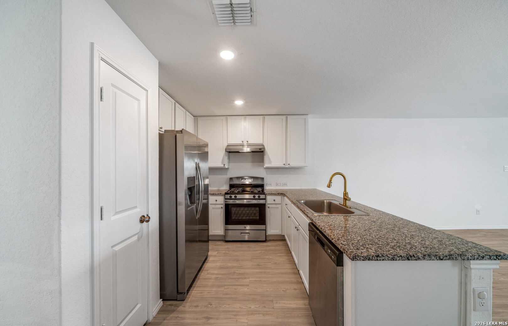 6566 Runaway Row Converse, TX 78109 - Photo 11 of 27 a kitchen with stainless steel appliances granite countertop a refrigerator a sink a stove and oven