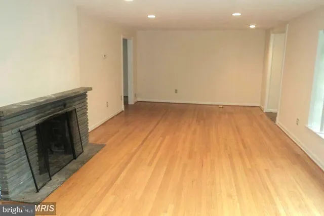 a view of an empty room and wooden floor