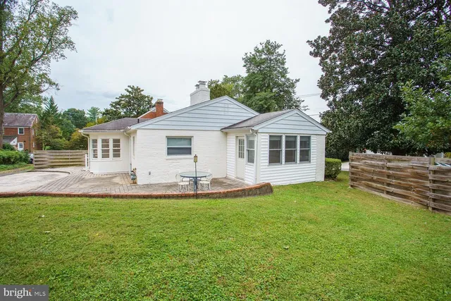 a front view of a house with a garden and yard