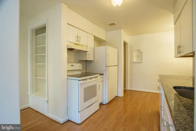 a kitchen with stainless steel appliances a refrigerator and a stove