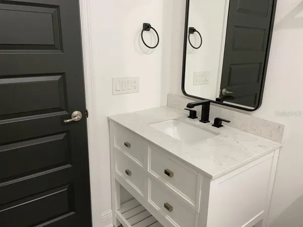 a bathroom with a sink and a mirror
