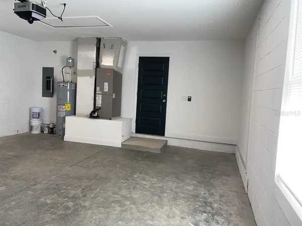 a view of a hallway with stairs and a window