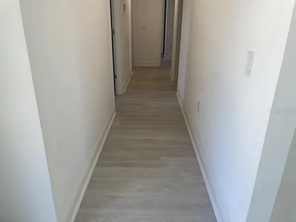 a view of a hallway with a white door
