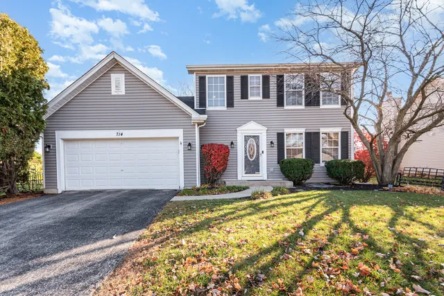 a front view of house with yard and trees around