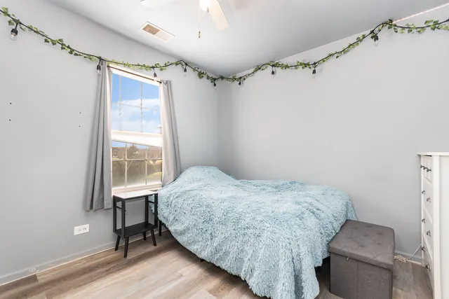 a bedroom with bed and a window