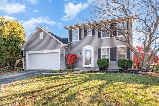 a front view of house with yard and trees around