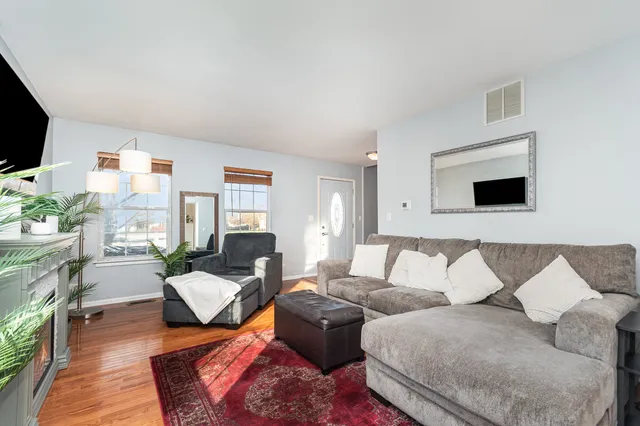 a living room with furniture wooden floor and a flat screen tv