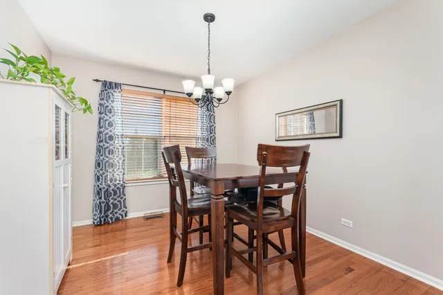 a view of a dining room with furniture and chandelier