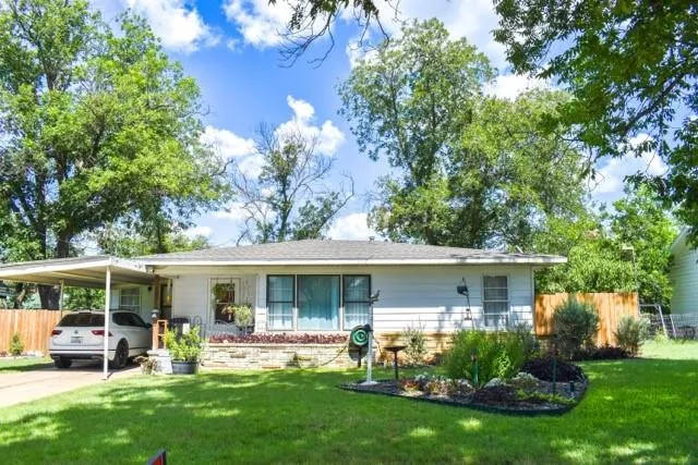 a front view of house with a garden and patio
