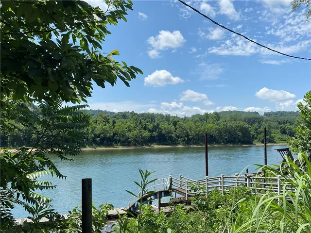 a view of a lake with a table and chairs