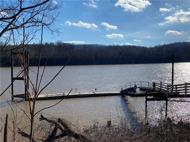 a room with gym equipment and large windows