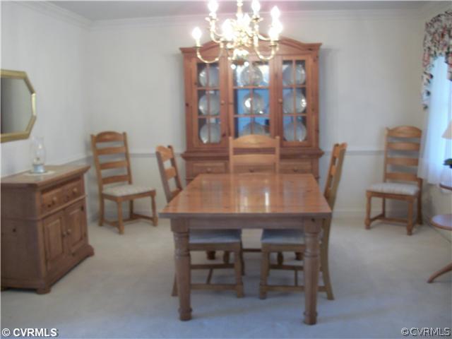2541 Radstock Road Midlothian, VA 23113 - Photo 3 of 12 a view of a dining room with furniture and chandelier