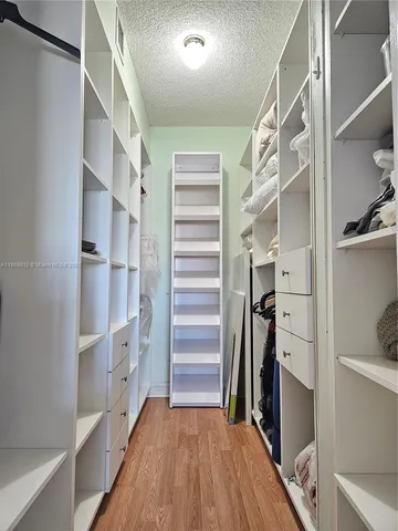 a view of walk in closet with empty racks