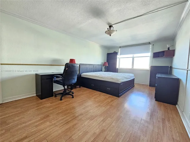 a bedroom with a bed and a chair