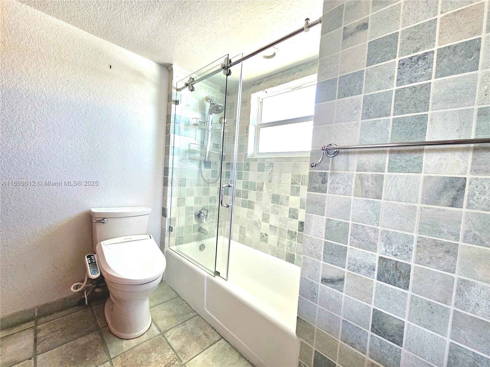 427 Golden Isles Drive, Unit 16E Hallandale Beach, FL 33009 - Photo 9 of 17 a bathroom with a toilet and a shower