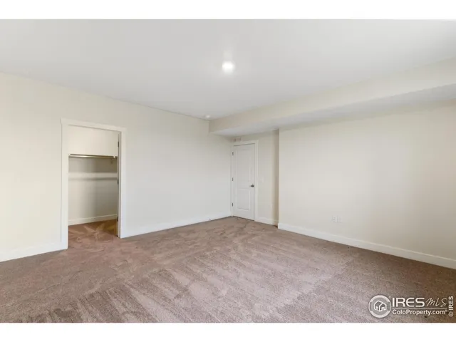 a view of an empty room and kitchen space