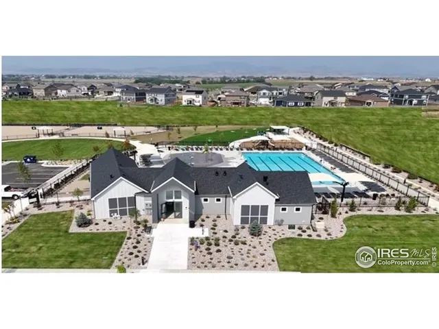 an aerial view of residential houses with outdoor space and river