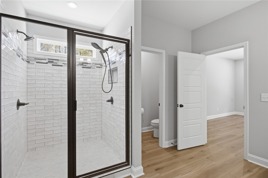 912 Watercrest Road West Union, SC 29696 - Photo 22 of 49 This spacious shower features sleek tile work and ample light, offering a refreshing retreat.