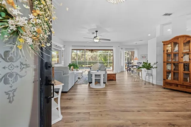 a living room with furniture and kitchen view