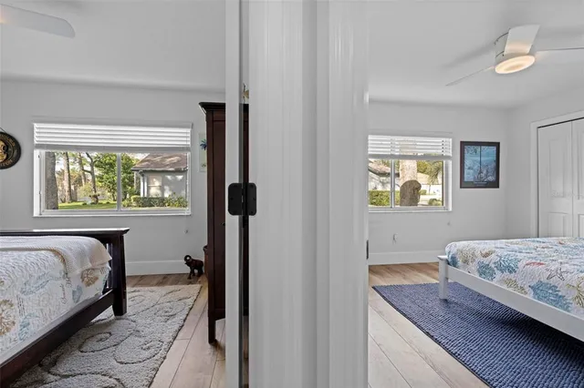 a bedroom with a large bed and a flat tv screen on dresser
