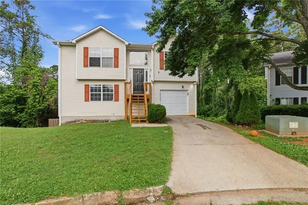 a front view of a house with a yard