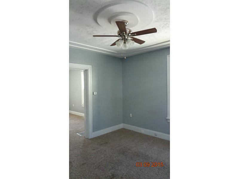 321 Federal Street Butler, PA 16001 - Photo 7 of 17 Living Room. Notice the decorative ceiling and wide baseboard trim